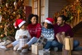 Overjoyed African American family with kids unpacking Christmas gifts Royalty Free Stock Photo