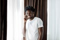 Overjoyed african American millennial man laugh having pleasant cellphone conversation, happy biracial male smile Royalty Free Stock Photo