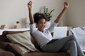 Overjoyed African American woman celebrating success, looking at laptop screen Royalty Free Stock Photo