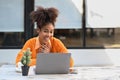 Overjoyed African American woman getting mail, read good news on laptop while sitting outdoor