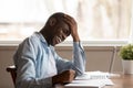 Overjoyed biracial man work at laptop laughing at joke