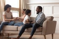 Overjoyed black family with kids play together on couch Royalty Free Stock Photo