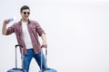 Overjoyed boy with suitcases and travel documents is eager to discover new destination and feelings. Royalty Free Stock Photo