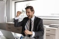 Overjoyed businessman wearing suit looking at laptop screen, reading news