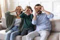 Overjoyed couple playing tricks fool with son at home.