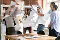 Overjoyed diverse employees throw papers celebrating success Royalty Free Stock Photo
