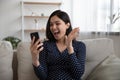 Overjoyed emotional happy millennial asian woman celebrating getting win notification.