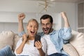 Overjoyed emotional young family couple celebrating online lottery win. Royalty Free Stock Photo