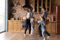 Overjoyed family dancing at kitchen celebrating moving to new home Royalty Free Stock Photo