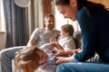 Overjoyed family with small kids play at home