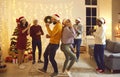 Overjoyed friends dance celebrate winter holidays together