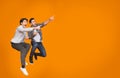 Overjoyed guys pointing at free space and jumping Royalty Free Stock Photo