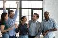 Overjoyed happy diverse business team celebrating success together