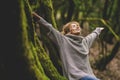 Overjoyed happy woman enjoying the green beautiful nature woods forest around her - concept of female people and healthy natural Royalty Free Stock Photo