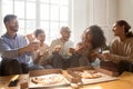 Excited multiracial young people have fun enjoying pizza Royalty Free Stock Photo