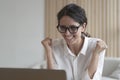 Overjoyed italian business woman clenching fists while getting pleasant news on computer Royalty Free Stock Photo