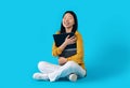 Overjoyed korean woman hugging laptop, blue background Royalty Free Stock Photo