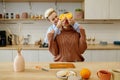Overjoyed LGBTQ couple woman lovers fooling around while preparing dinner