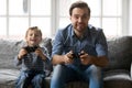 Overjoyed little child son playing with father.