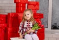 Overjoyed little girl holding a pile of presents. Valentines day