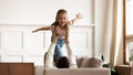 Overjoyed little girl playing with loving dad at home