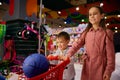 Overjoyed little sister and brother doing shopping in toys shop