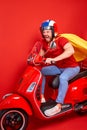 Overjoyed mad crazy man driving moped fast speed wearing super hero costume