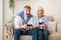 Overjoyed mature couple playing video games at home Royalty Free Stock Photo