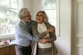 Overjoyed mature man and woman dancing in kitchen, having fun Royalty Free Stock Photo