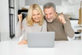 Overjoyed middle-age couple win in online lottery, received good news Royalty Free Stock Photo