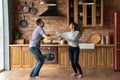 Overjoyed millennial couple dancing at kitchen excited with relocation Royalty Free Stock Photo