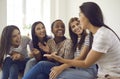 Overjoyed millennial diverse girls relax together at home