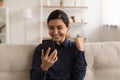 Overjoyed millennial indian woman receive perfect discount from internet shop