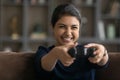 Overjoyed Indian teenager have fun playing video games