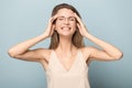 Overjoyed millennial woman in glasses laughing in studio