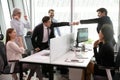 Overjoyed mixed race colleagues watching two teammates bumping fists. Royalty Free Stock Photo