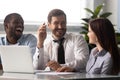 Overjoyed multiethnic colleagues have fun laugh at briefing Royalty Free Stock Photo