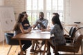 Smiling diverse colleagues brainstorm laugh at office meeting Royalty Free Stock Photo