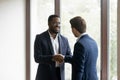 Overjoyed multiracial business partners shake hands after meeting Royalty Free Stock Photo