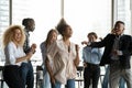 Overjoyed multiracial colleagues dance have fun in office