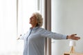 Overjoyed old woman stretch at home feeling positive Royalty Free Stock Photo