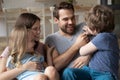 Overjoyed parents enjoying leisure weekend time with small kids. Royalty Free Stock Photo