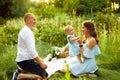 Overjoyed parents with young daughter having a picnic Royalty Free Stock Photo