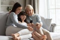 Happy three generations of women relax using cellphone Royalty Free Stock Photo