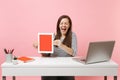 Overjoyed woman with closed eyes hold tablet computer with blank empty screen, sit work at white desk with contemporary Royalty Free Stock Photo