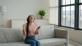 Overjoyed woman girl female on sofa use mobile phone excited winner customer get e-commerce shopping offer winning bid Royalty Free Stock Photo