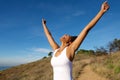 Overjoyed woman outdoors with her arms wide open