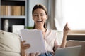 Overjoyed woman reading good news in letter, celebrating success Royalty Free Stock Photo