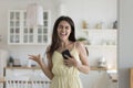 Overjoyed woman sing song holds cellphone dancing at home Royalty Free Stock Photo
