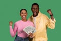 Overjoyed young African American couple holding bunch of money Royalty Free Stock Photo